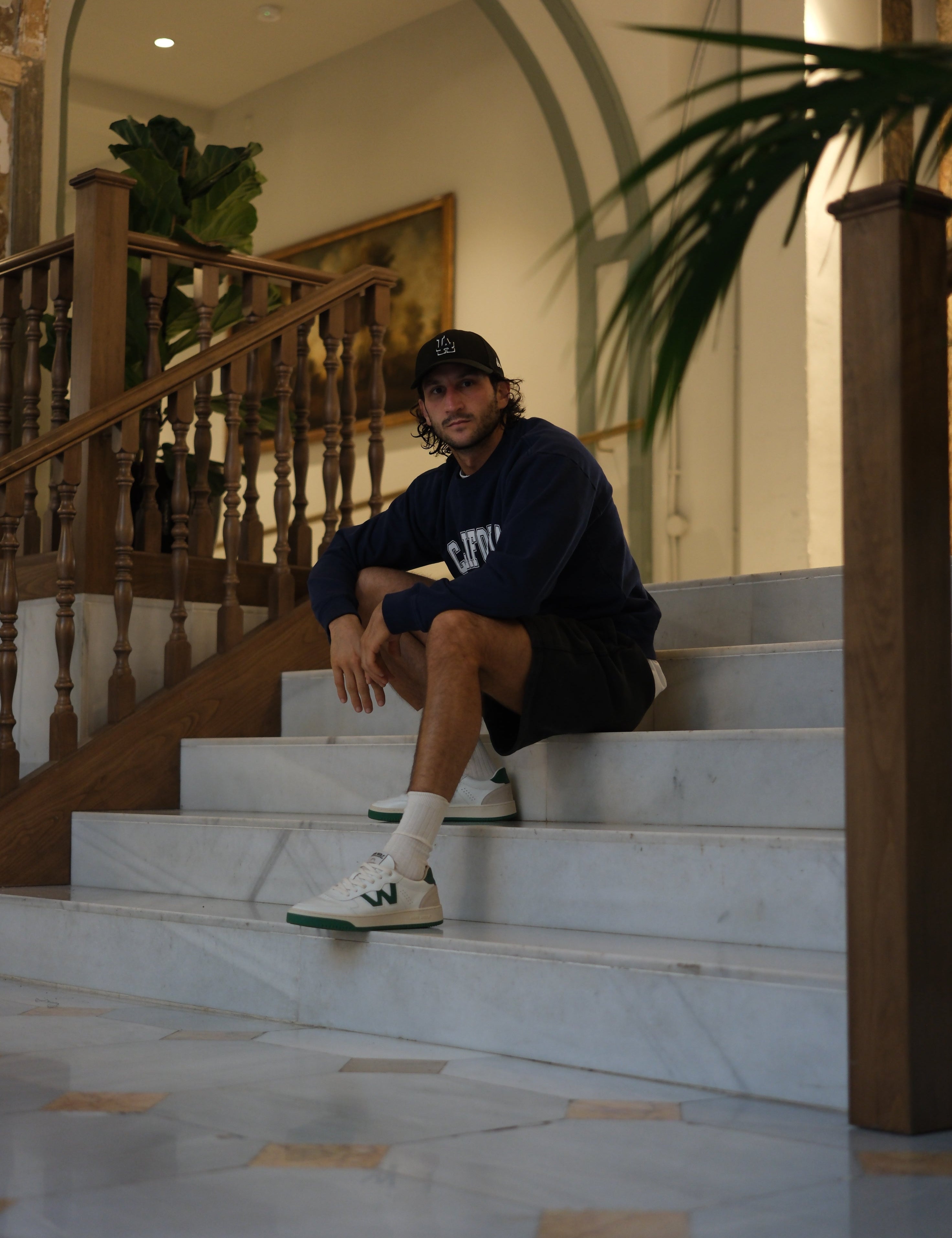 Man seating on stairs wearing Bob Wolf Legacy model